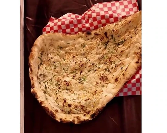 Garlic naan at Saffron Indian Bistro in Lake Louise, Alberta — tandoor-baked flatbread brushed with garlic and herbs