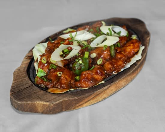 Saffron Special Chicken Curry at Saffron Indian Bistro Banff - chicken in a rich spiced sauce served sizzling with peppers and onions